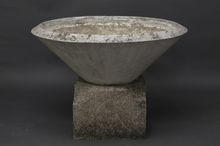 A large and impressive circular garden urn raised on a granite base 36"
