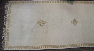 A white ground Indian carpet having 3 stylised octagons to the  centre 155" x 58"