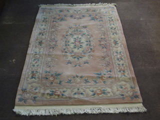 A peach ground and floral patterned Chinese rug 71" x 46"