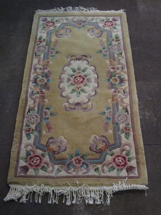 A yellow ground and floral patterned Chinese rug 60" x 31"