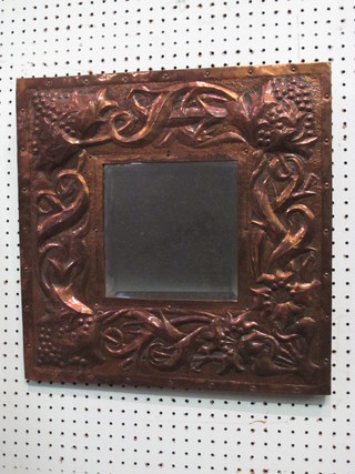 An Art Nouveau square bevelled plate wall mirror contained in  an embossed copper frame 18" x 17"
