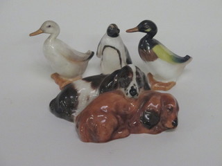 A Royal Doulton figure of 2 curled Spaniels, the base marked  HN2590G 4" and 2 Royal Doulton figures of ducks, 1 second?,  and a figure of a penguin