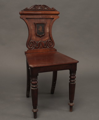A 19th Century mahogany shield shaped hall chair with solid seat  raised on turned supports