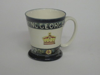 A Moorcroft Coronation mug to commemorate the Coronation of  George V and Queen Elizabeth 1937, the base impressed Moorcroft Potter to the Queen and with signature mark 5", some  crazing  ILLUSTRATED