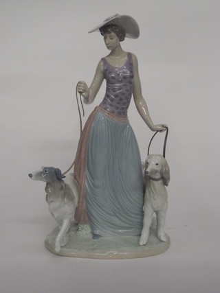 A Lladro figure of a standing lady with 2 Afghan hounds, the  base marked 5802 15"