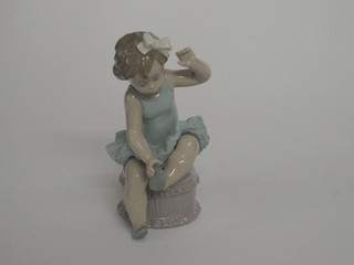 A Lladro figure of a seated child ballet dancer, the base marked Daisa 1980, 6"