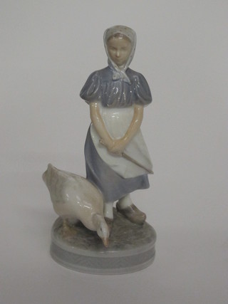 A Royal Copenhagen figure of a standing girl with goose, the base marked 527 9 1/2"