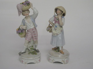 A pair of 19th Century Continental porcelain figures - Boy and  Girl with baskets of fruit, the base with stylised cross sword  mark, 10 1/2"