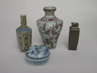 An Oriental blue and white jar and cover, the lid decorated  figures the base with 6 character mark 3", a square brown glazed  vase 5", a yellow and blue floral glazed club shaped vase the base  with seal mark 7" and an Oriental club vase with ring mask  handles 8"