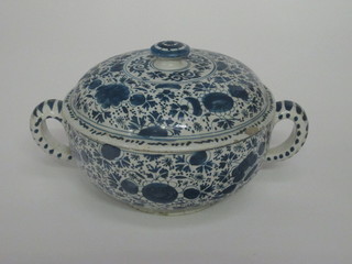 An 18th Century Delft blue and white twin handled straining  bowl and cover, crack to base 9"  ILLUSTRATED