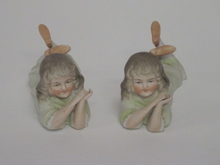 A pair of biscuit porcelain figures of reclining girls 5", 1 f and r,