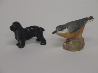 A Royal Worcester porcelain figure of a standing black Spaniel, the base marked 2944 2" together with a do. figure of a Nuthatch  3334