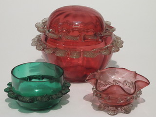 A Victorian circular cranberry glass jar and cover 4 1/2", some chips to trim, a cranberry glass bowl with wavy glass border and  clear glass feet and a green bowl bowl 3"