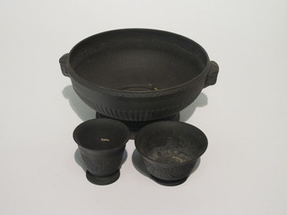 A circular black basalt twin handle bowl raised on a circular  spreading foot 9" and 2 small basalt bowls