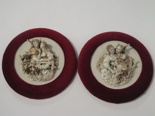 A pair of Continental relief porcelain plaques depicting figures 7"