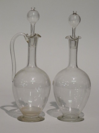 A glass club shaped decanter and stopper and a ewer and stopper