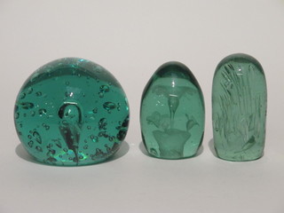 A circular green glass bubble dump paperweight 4" and 2 other  green glass paperweights