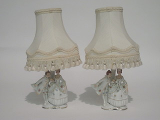 A pair of porcelain table lamps in the form of a standing lady and gentleman 6"