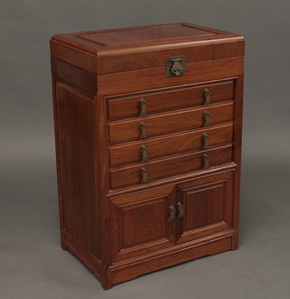 An Oriental hardwood cutlery cabinet with hinged lid, the base fitted 4 long drawers above a double cupboard 22"