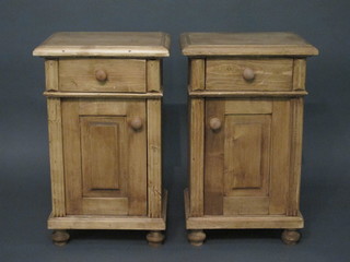 A pair of Continental polished pine bedside cabinets fitted a drawer above a cupboard, raised on bun feet 17"