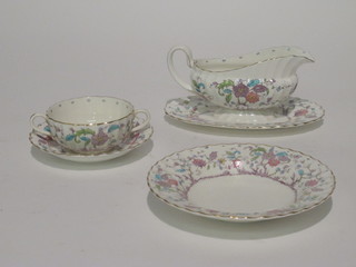 A 76 piece Royal Worcester Kashmir pattern dinner service comprising oval meat plate 17", 2 oval meat plates 15 1/2", 2  sauce boats, 6 dinner plates 10" - gilding rubbed, 12 side plates  9" - 3 cracked, 11 side plates 8", 10 tea plates 6", 8 twin  handled soup bowls - 3 cracked, 12 saucers 6", 12 soup/pudding  bowls 8"