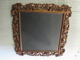 A rectangular bevelled plate mirror contained in a carved gilt painted frame 30"