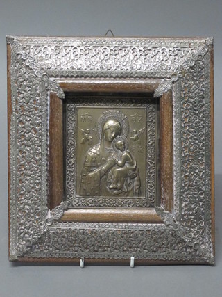 An embossed metal Icon "Standing Virgin and Christ" contained  in a pierced white metal frame 10" x 9"