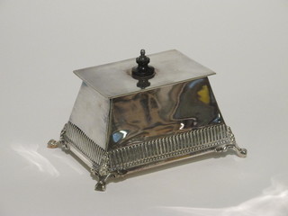 A rectangular silver plated caddy with hinged lid, raised on hoof feet 5"