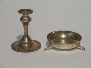A silver stub candlestick 3" and a circular silver dish raised on 3  bun feet 2"