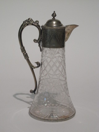 An etched and cut glass claret jug with silver plated mount