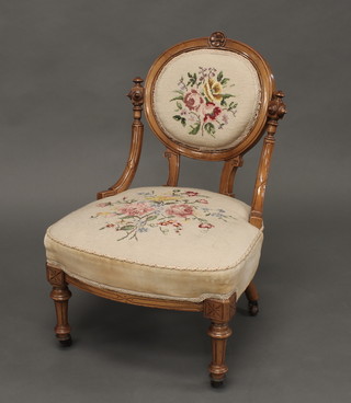 A Victorian mahogany show frame nursing chair, with Berlin woolwork upholstered seat and back, raised on turned and fluted  supports