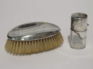 A Victorian cylindrical glass salts bottle with silver double hinged lid, glass cracked, London 1893, together with a silver backed  military hair brush