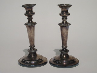 A pair of silver plated candlesticks with detachable sconces