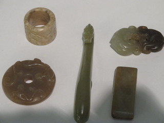 A green hardstone dewy-sceptre 3 1/2", a carved hardstone ring, 2 hardstone pendants 1" and a rectangular "buckle",