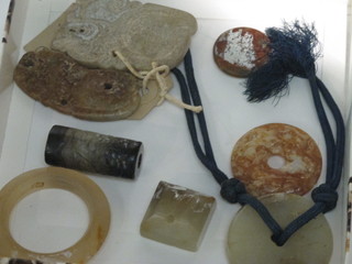 2 circular carved hardstone pendants, a hardstone seal, a pendant  decorated an animal, 1 other, a hardstone ring and a bead