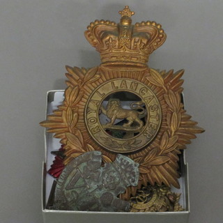 A Victorian Royal Lancashire Regt. helmet plate, a WWI  German Cross of Honour with crossed swords, a Trench Art Iron  Cross, 1 other medal and 3 cap badges