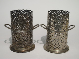 A pair of WMF pierced silver plated soda siphon/wine bottle holders