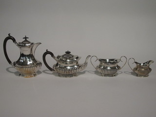 A silver 4 piece tea service of oval form with demi-reeded decoration, Birmingham 1911 and 1914 comprising teapot,  hotwater jug, twin handled sugar bowl and cream jug 47 ozs   ILLUSTRATED