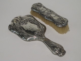 An Edwardian embossed silver backed hand mirror ,f, with matching clothes brush, Chester 1905