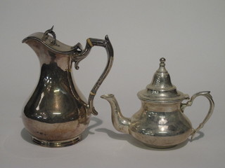 A silver plated hotwater jug with armorial decoration and a small silver plated teapot