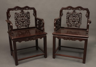 A pair of Oriental hardwood throne chairs with pierced backs  and solid seats
