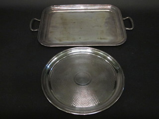 A circular silver plated salver with engine turned decoration 12" and a silver plated twin handled tea tray 15 1/2"