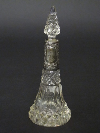 A waisted cut glass perfume bottle with embossed silver mount