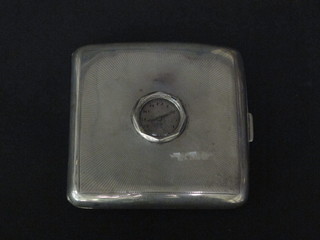A silver cigarette case with engine turned decoration incorporating an aperture for watch, Birmingham 1935
