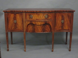 A Georgian style mahogany sideboard of serpentine outline fitted  2 long drawers flanked by a pair of cupboard, raised on square  tapering supports ending in spade feet 60"