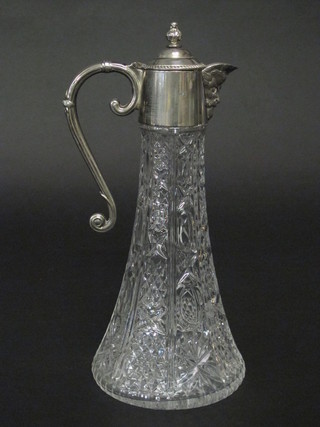 A glass claret jug with silver plated mounts