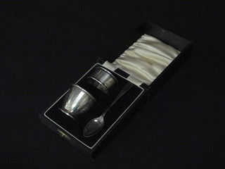 A silver christening set comprising egg cup and matching napkin  ring Birmingham 1933 and a silver plated spoon, 1 ozs, cased