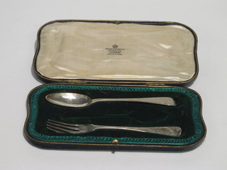 A Victorian 2 piece christening set comprising engraved silver  spoon and fork, London 1870, 2 ozs, cased