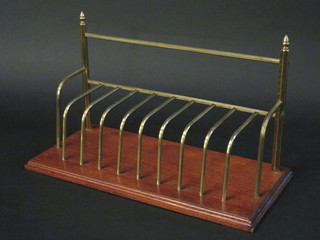 A 19th Century rectangular brass and mahogany letter rack 18"