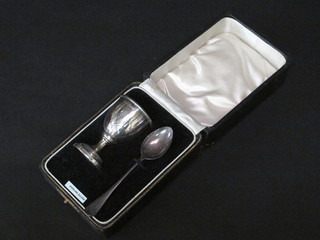 A silver egg cup together with spoon, Birmingham 1936, cased